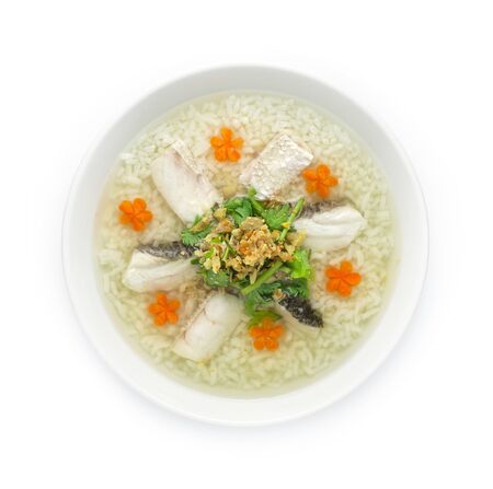 Rice Porridge boiled with Asian Seabass fish Cutlet cooking tasty Maincorse Thai food fusion style decorate mix Chinese food style decorate with carved carrots and vegetable cutlet top viewの写真素材