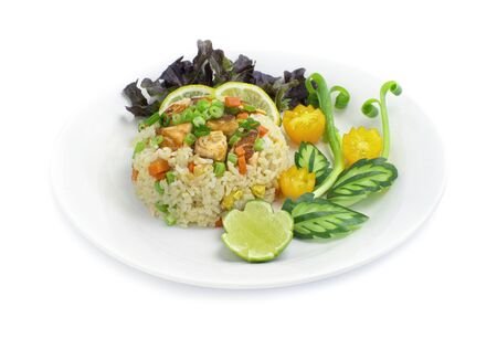 Fried Rice with Salmon Thai food fusion style decorate vegetables carved and tomato, cucumber side viewの写真素材