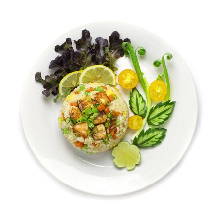 Fried Rice with Salmon Thai food fusion style decorate vegetables carved and tomato, cucumber top viewの写真素材