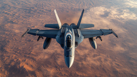 Fighter jet flies high above dramatic desert landscape under a bright sky.の素材