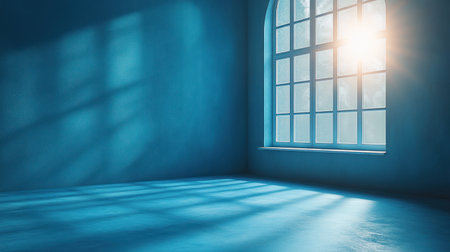 Morning sunlight streams through the window, casting shadows in a tranquil blue space.の素材
