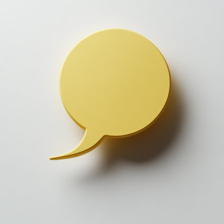Bright yellow speech bubble on a white surface, perfect for visual communication.の素材