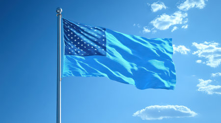 Bright blue flag with stars flutters in the wind against a serene sky and gentle clouds.の素材