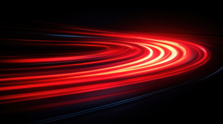 Curvy trails of brilliant red light flow gently, evoking a sense of speed and movement.の素材