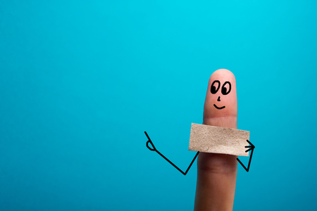 Funny finger holding blank bunner and smiling.の写真素材