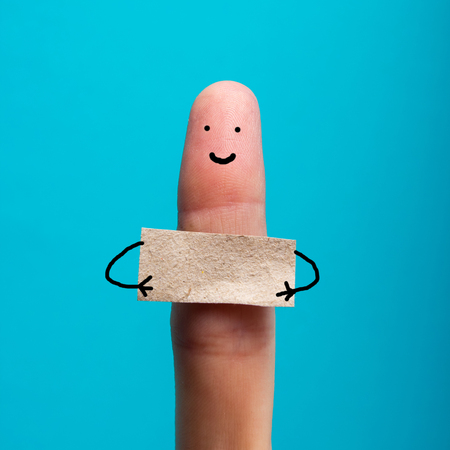 Funny finger holding blank bunner and smiling.の写真素材