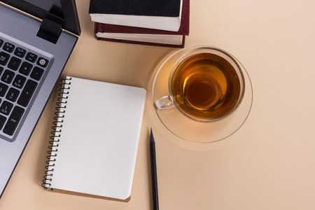 Office table with notepad, computer and coffee cup. View from above with copy space. Business...