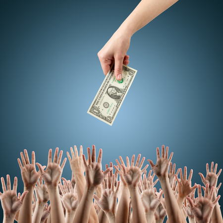 Hand with money on a blue background Money background - American dollarsの写真素材