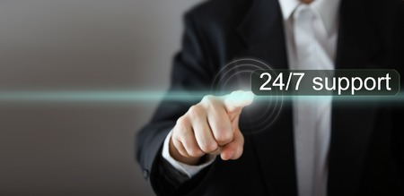 Businessman's hand pressing the icon with text on virtual screens. Business, technology, internet and networking concept. Copy spaceの写真素材