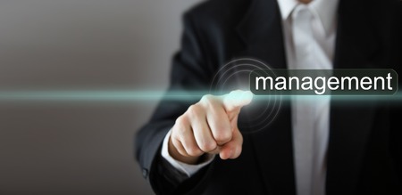 Businessman's hand pressing the icon with text on virtual screens. Business, technology, internet and networking concept. Copy spaceの写真素材