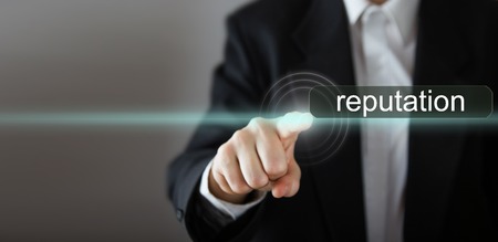 Businessman's hand pressing the icon with text on virtual screens. Business, technology, internet and networking concept. Copy spaceの写真素材