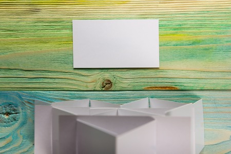 White blank business visit card, gift, ticket, pass, present close up on blurred blue background. Blank corporate identity package business card. Template for IDの写真素材