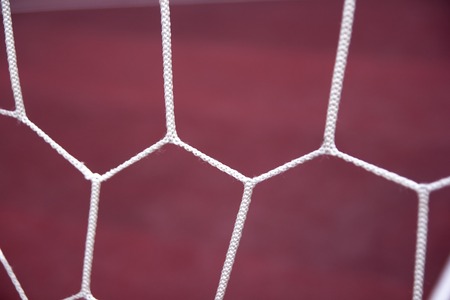 Soccer goal net on red background. Sport theme