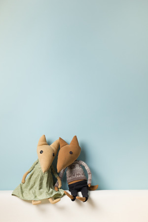 Home interior. Childhood. Blue background. Toy sitting on a couch. Copy spaceの写真素材