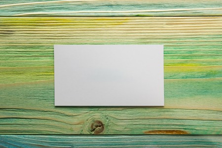 White blank business visit card, gift, ticket, pass, present close up on blurred blue background. Blank corporate identity package business card. Template for IDの写真素材