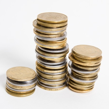 Columns of coins isolated on white background.の写真素材