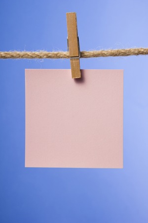 Blank paper notes hanging on rope with clothes pins, copy space for text or image or product placement. Reminderの写真素材