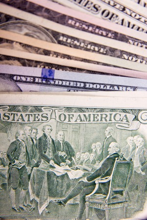 Bribe in businessmen's pocket. One hundred dollars banknoteの写真素材