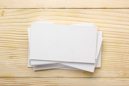 White blank business visit card, gift, ticket, pass, present close up on wooden background. Copy...