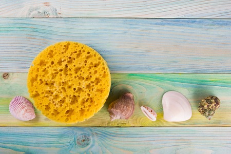 Summer sea vacation background. Notebook blank page with Travel items on blue green wooden table. Sea shells, pebbles, top view mockupの写真素材