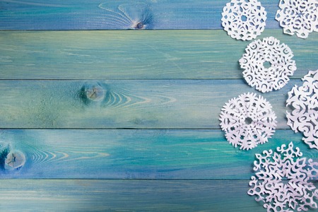 Christmas fir tree with decoration on dark wooden board. Snowflakes border on grunge wooden background. Winter holidays conceptの写真素材