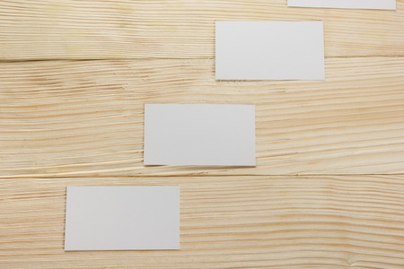 White blank business visit card, gift, ticket, pass, present close up on wooden background. Copy space Blank corporate identity package business card Template for IDの写真素材