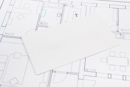 Architectural project, blueprints, silver key with house figure and blank business card on wooden background. Real Estate Concept. Top viewの写真素材