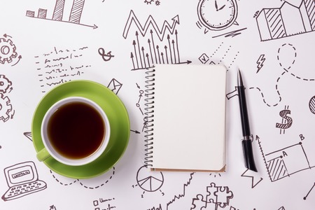 Office table desk with supplies, notepad, computer and coffee cup. Business creative concept.の写真素材