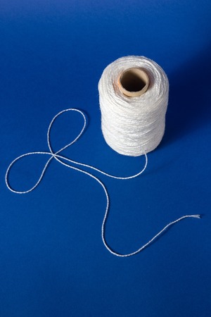 White thread isolated on white background. Rope, wool, knitting homemade handmade objectの写真素材