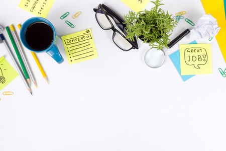 Office table desk with supplies, notepad, and coffee cup. Business creative concept. Copy space.