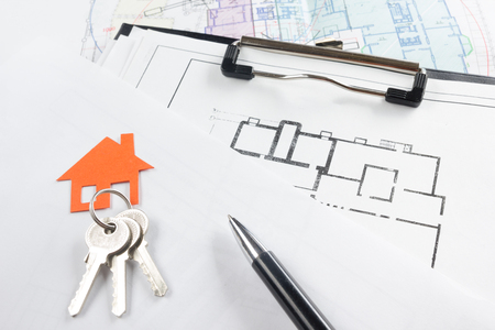 Model house, construction plan for house building, keys, pens and clipboard. Real Estate Concept. Top viewの写真素材
