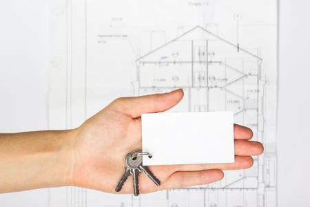 Blank business card on construction plan background. Real Estate Concept. Top view.
