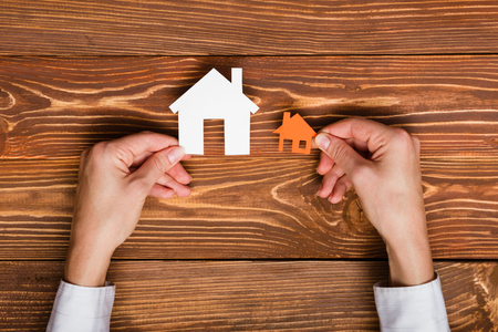 Paper house figure on wooden background. Real Estate Concept. Top view.の写真素材