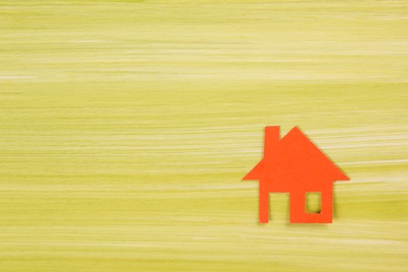 Paper house figure on wooden background. Real Estate Concept. Top view.