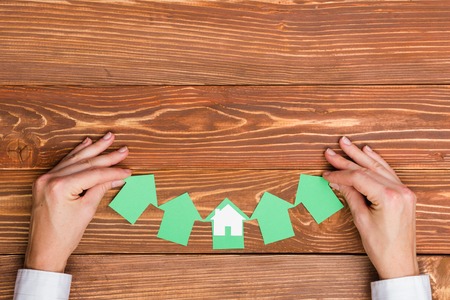 Paper house figure on wooden background. Real Estate Concept. Top view.の写真素材