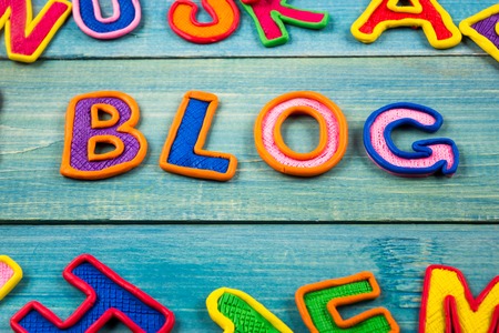 Word BLOG made with plasticine letters on old wooden blue board backgroundの写真素材