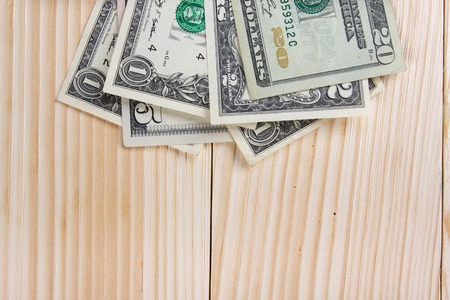 Money dollars euro cents on wooden table desk background with copy space for ad text.