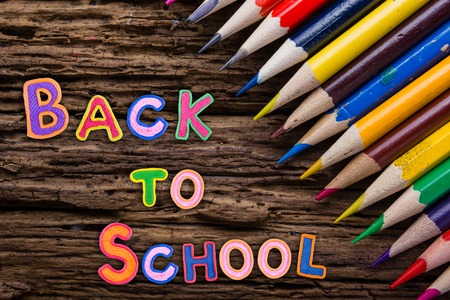 Back to School desk table top view, words on grunge old wooden board background. Education concept. Time to learnの写真素材