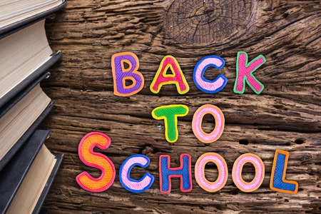 Back to School desk table top view, words on grunge old wooden board background. Education concept. Time to learnの写真素材