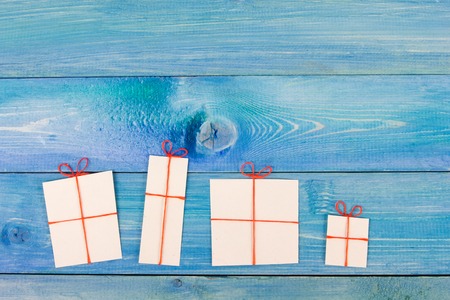 Christmas present box over blue wooden background, above view