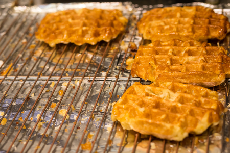 Cooking Belgian waffles in bakery - food background. Gaufres au sucreの写真素材