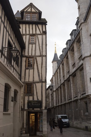 Old and tilted houses at Rue Eau de Robec in Rouen on a rainy day. Rue Eau-de-Robec is one of the main tourist streets of Rouen. Upper Normandy, France.のeditorial素材