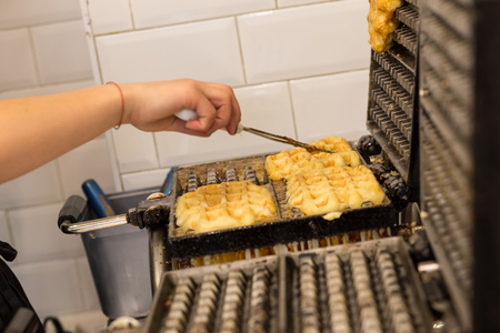 Cooking Belgian waffles in bakery - food background. Gaufres au sucreの写真素材