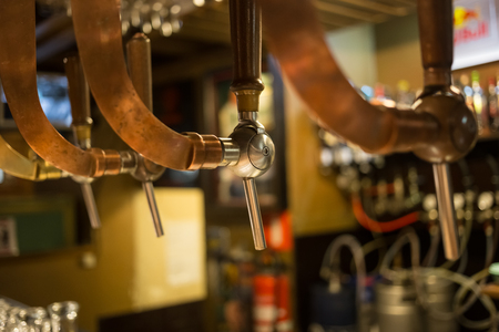 Beer bar pub tap, counter with blur pub background. Brussel Belgiumの写真素材