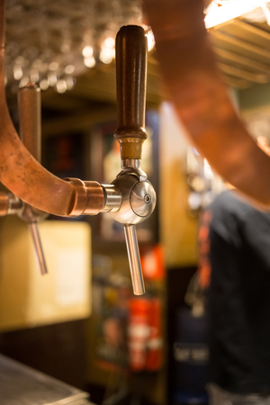 Beer bar pub tap, counter with blur pub background. Brussel Belgiumの写真素材