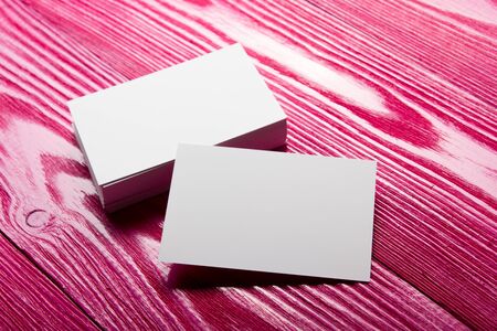 Business card blank on wooden background. Corporate Stationery, Branding Mock-up. Creative designer desk. Flat lay. Copy space for textの写真素材