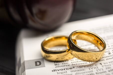Divorce and separation concept. Two golden wedding rings. Dictionary definitionの写真素材