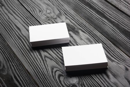 Business card blank on wooden background. Corporate Stationery, Branding Mock-up. Creative designer desk. Flat lay. Copy space for textの写真素材