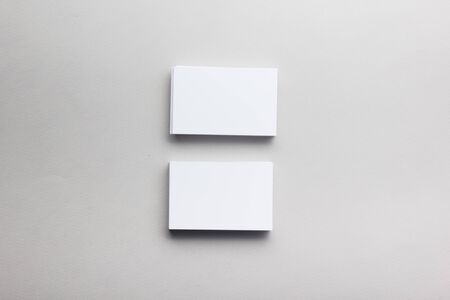 Business card blank on wooden background. Corporate Stationery, Branding Mock-up. Creative designer desk. Flat lay. Copy space for textの写真素材