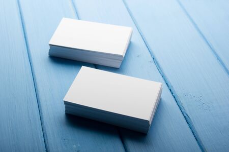 Business card blank on wooden background. Corporate Stationery, Branding Mock-up. Creative designer desk. Flat lay. Copy space for textの写真素材